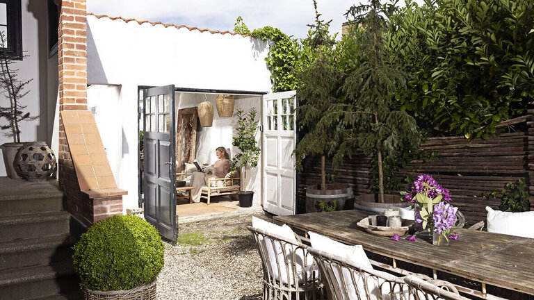 Kig fra gården og ind i garagen, der er blevet omdannet til orangeri