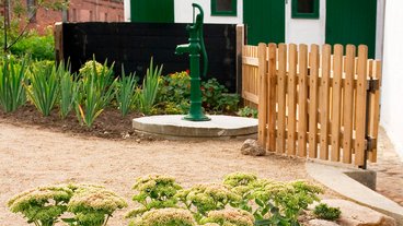 Gammeldags gårdpumpe støbejernspumpe på terrasse