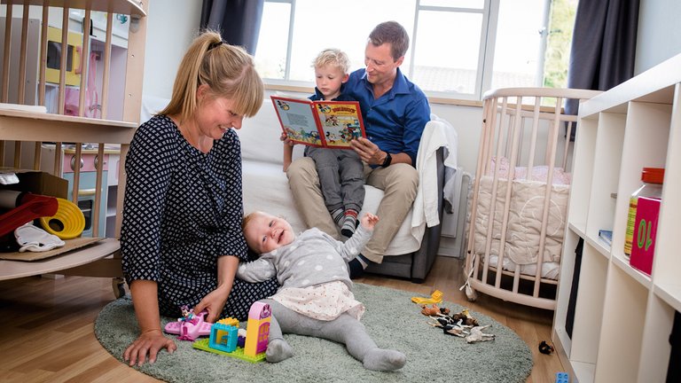 Familien med to voksne, Oskar på 4 år og Vilja på 1 år, på børneværelset.